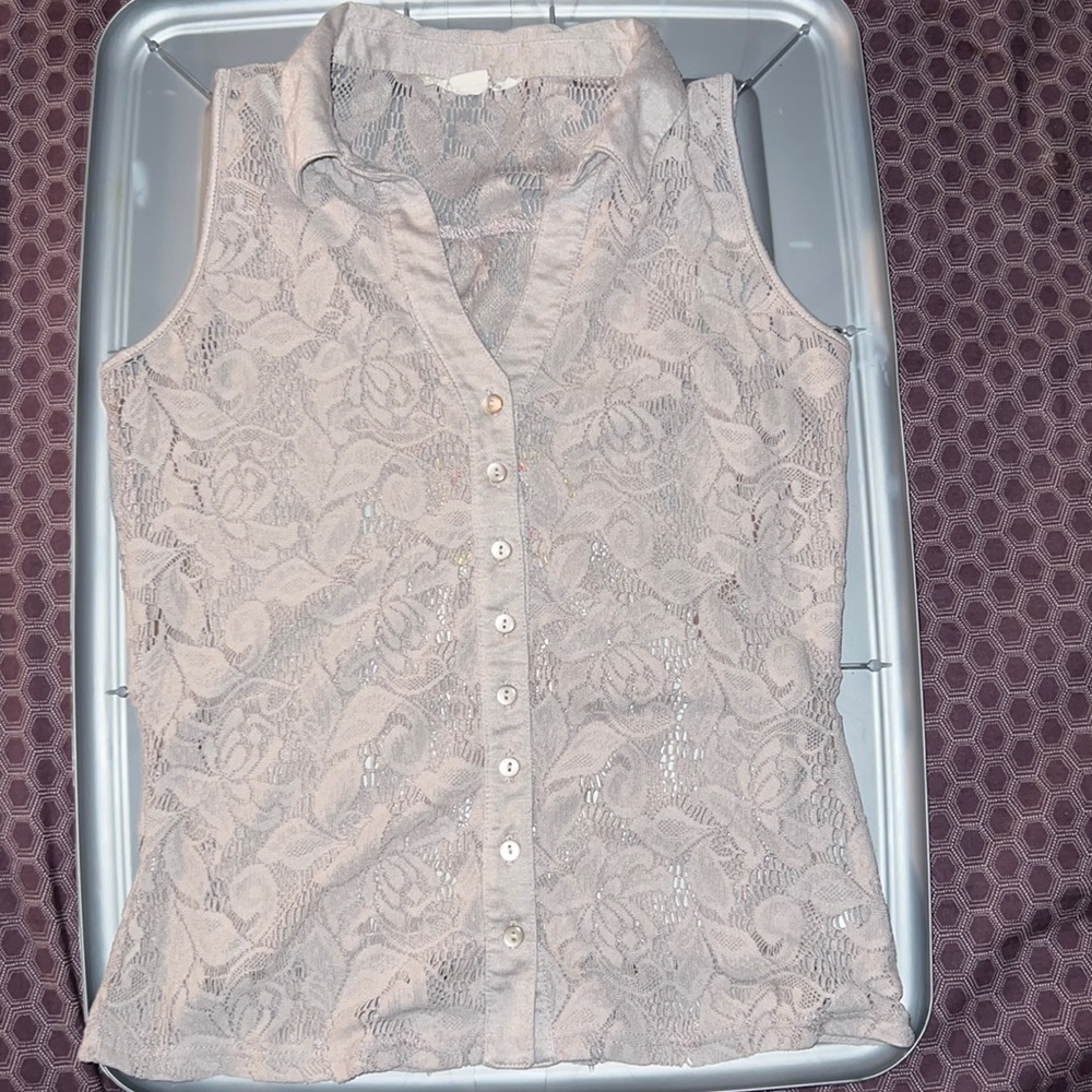 A medium size tan sleeveless blouse